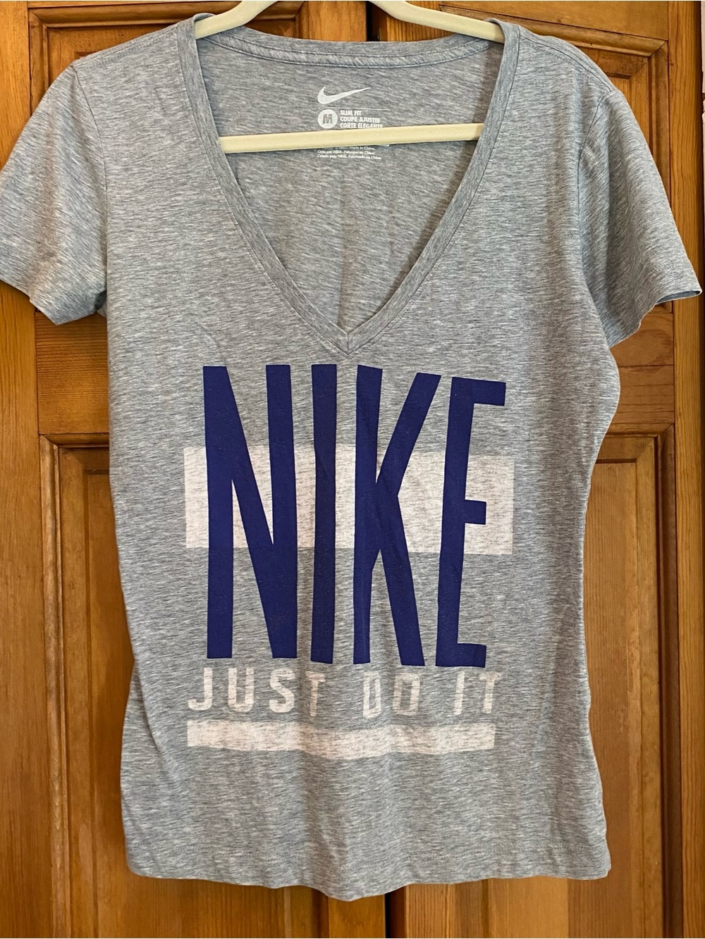 Nike Women’s Gray V-Neck Tee with Blue NIKE Block Logo